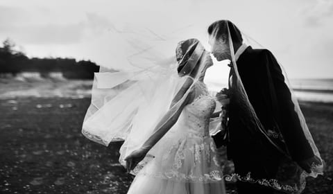 A black and white wedding kiss