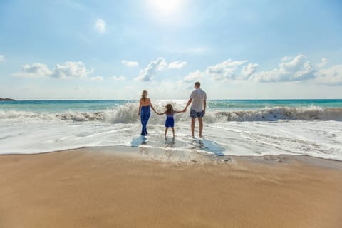 A family walking along the beach