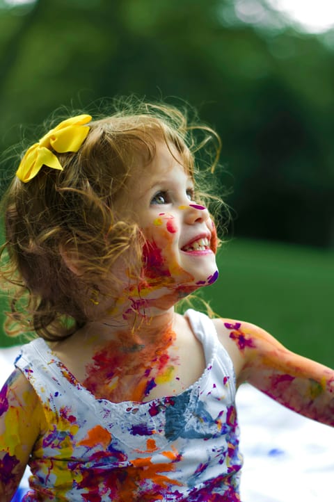 A child with paint on her face