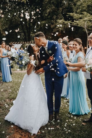 Bride and groom under falling confetti