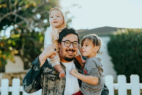 A father carrying his two children